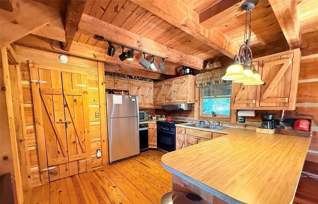 The kitchen bar and stools looking back through the pine-lined main level